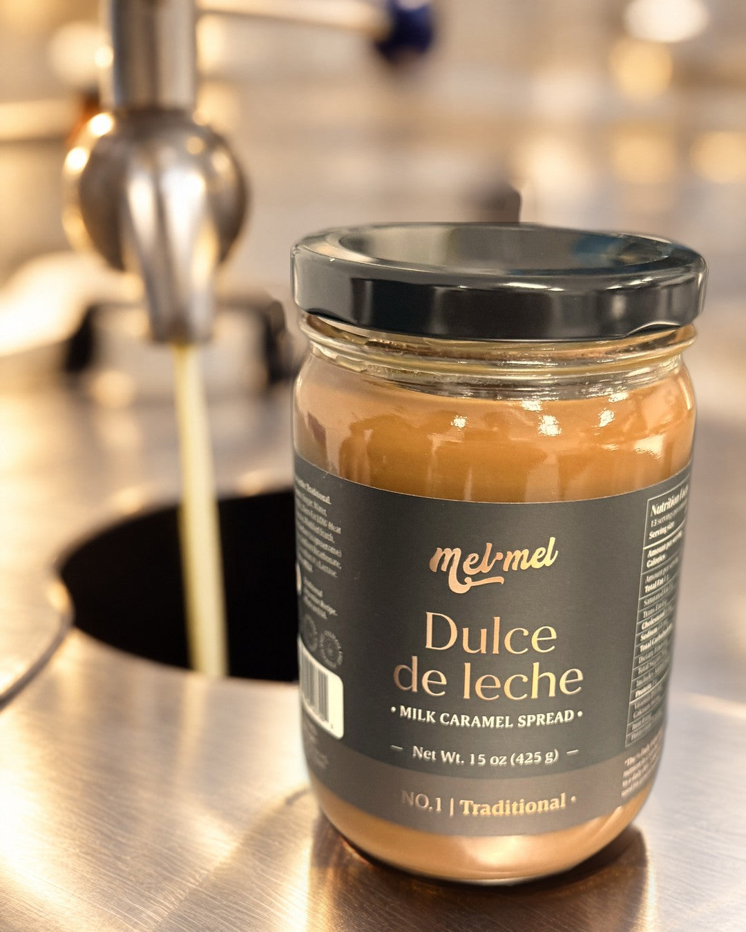 A 15 oz jar of Mel·Mel dulce de leche on the line in Delray Beach, with fresh milk pouring in behind it
